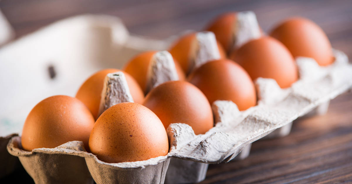 Chicken eggs are in the tray. Fresh chicken eggs in a tray on a rustic wooden table